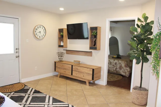 a living room with furniture and a potted plant