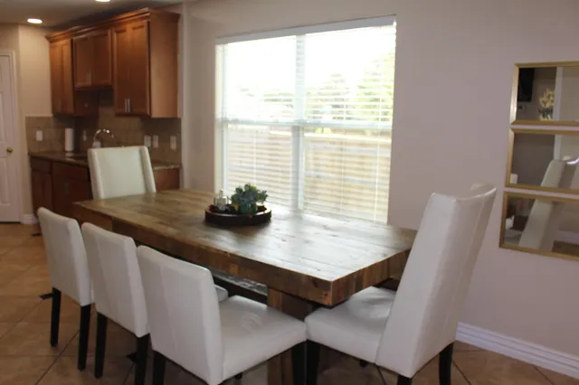 a view of a dining room with furniture and a window