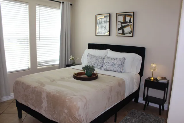 a bedroom with a bed and a table in it