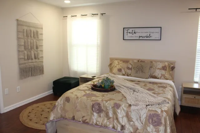 a bedroom with a bed and window