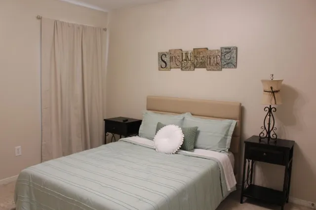 a bedroom with a bed and a window