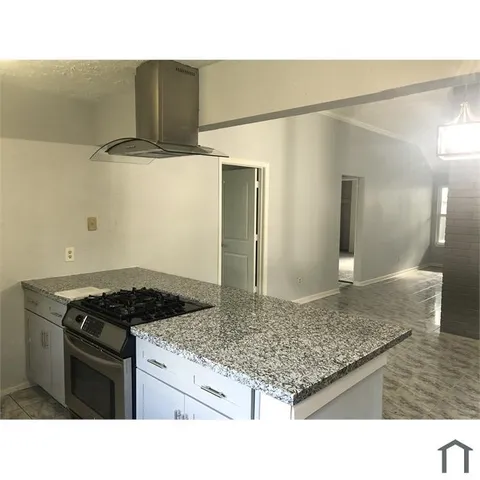 a kitchen with a sink a stove top oven and cabinets