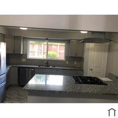 a kitchen with a sink cabinets and window