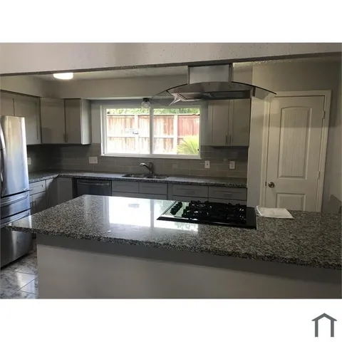 a kitchen with a refrigerator a stove a sink and a counter top space