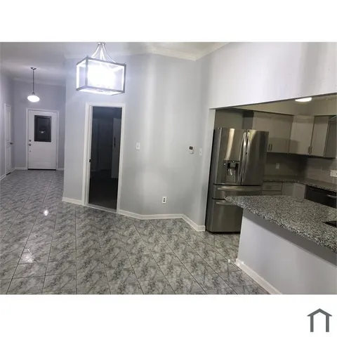 a open kitchen with a sink and a refrigerator