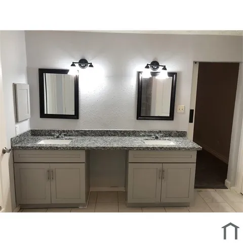 a bathroom with a sink a mirror and a vanity