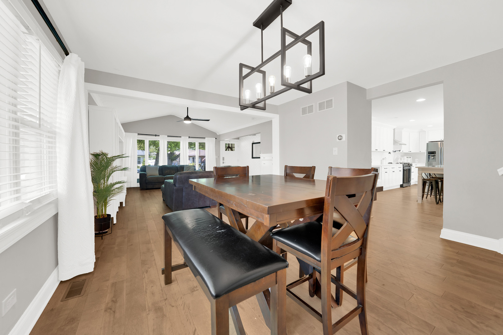 9737 West 57th Street Countryside, IL 60525 - Photo 3 of 19 a view of a dining room and livingroom with furniture wooden floor a chandelier