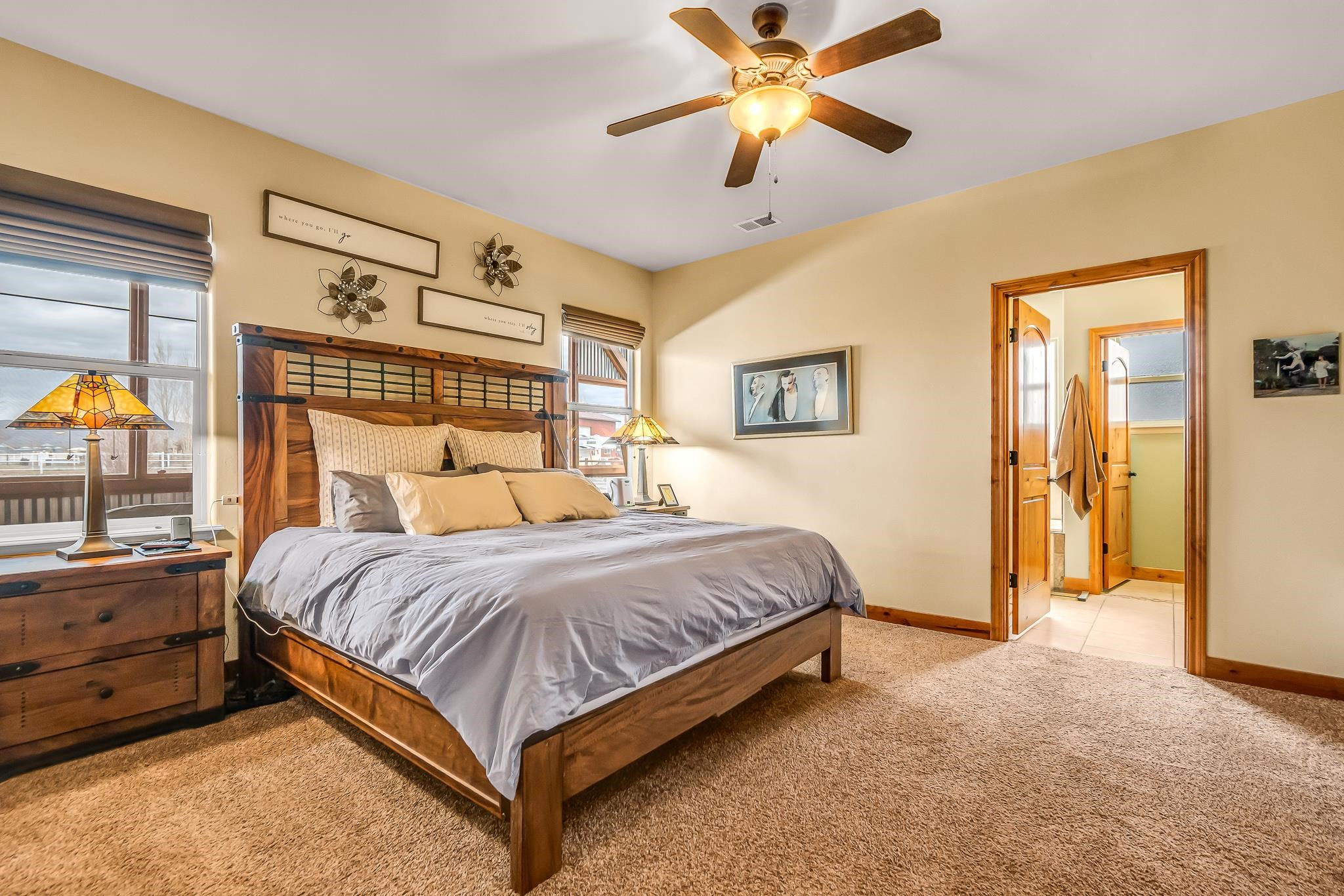 2028 Roma Avenue Fruita, CO 81521 - Photo 11 of 41 a spacious bedroom with a bed and a chandelier