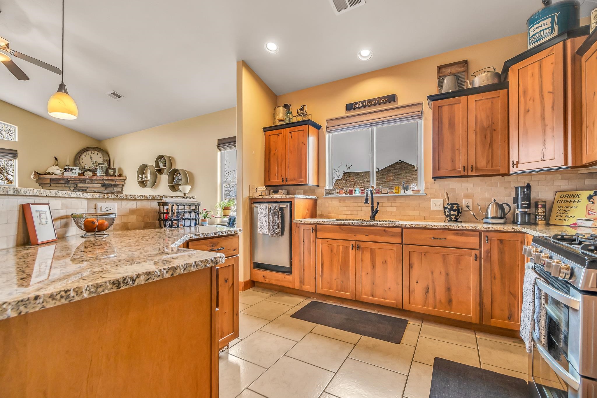 2028 Roma Avenue Fruita, CO 81521 - Photo 7 of 41 a kitchen with stainless steel appliances granite countertop a sink stove and cabinets