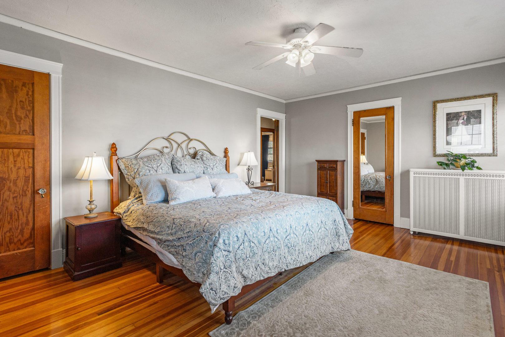 1124 North State Street Monticello, IL 61856 - Photo 30 of 53 a bedroom with a large bed and a chandelier