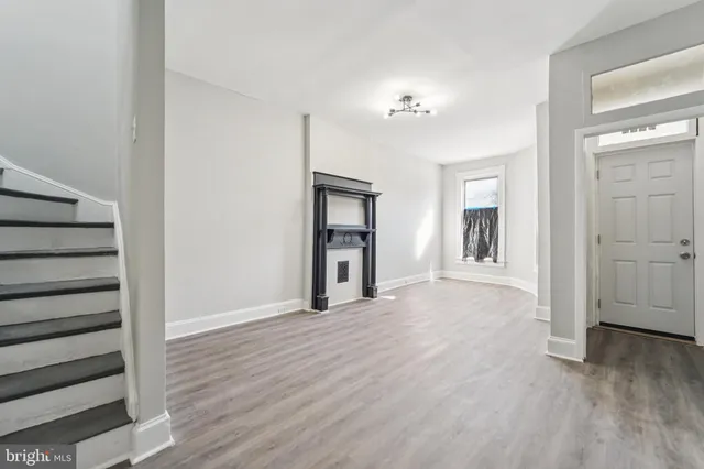 a view of a room with wooden floor and windows