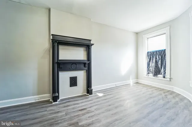 a view of hallway with wooden floor and stair