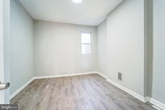 an empty room with wooden floor