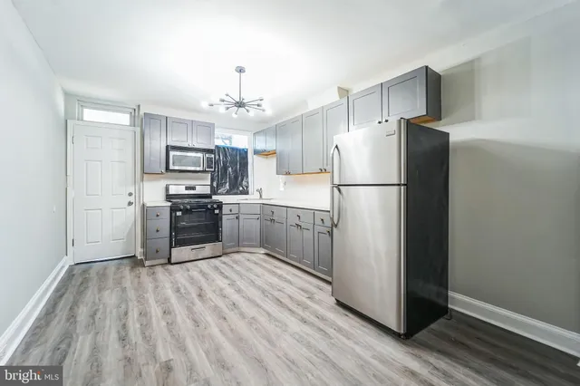 a kitchen with a refrigerator a sink and cabinets