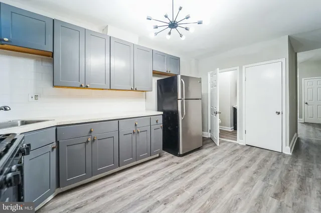 a kitchen with a sink appliances and cabinets