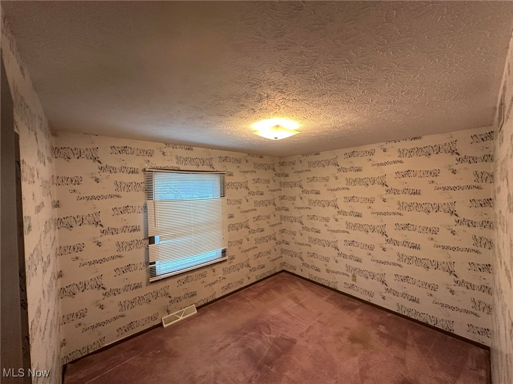 97 West Howe Road Tallmadge, OH 44278 - Photo 28 of 35 Empty room featuring a textured ceiling
