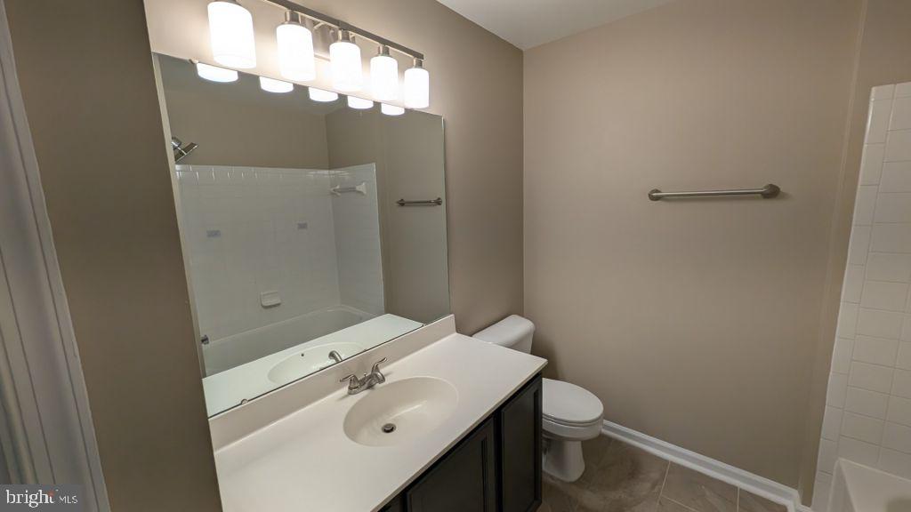 19919 Ridgecrest Square Ashburn, VA 20147 - Photo 16 of 22 a bathroom with a sink a toilet and shower