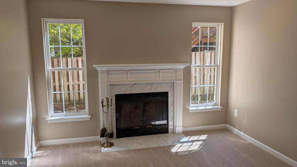 19919 Ridgecrest Square Ashburn, VA 20147 - Photo 20 of 22 a living room with a fireplace and a window