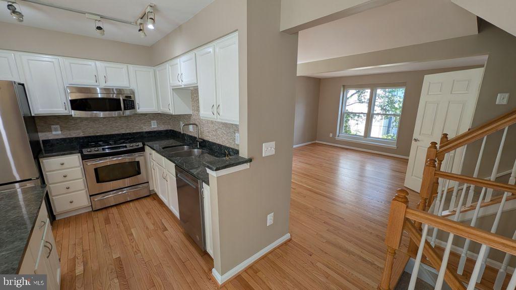 19919 Ridgecrest Square Ashburn, VA 20147 - Photo 6 of 22 a kitchen with stainless steel appliances granite countertop a stove a sink and a refrigerator