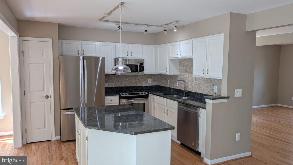 19919 Ridgecrest Square Ashburn, VA 20147 - Photo 7 of 22 a kitchen with stainless steel appliances granite countertop a refrigerator a stove a sink and a refrigerator
