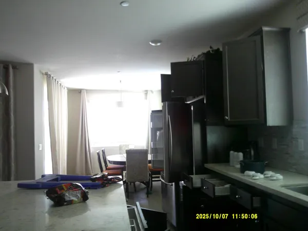 a kitchen with a refrigerator and window