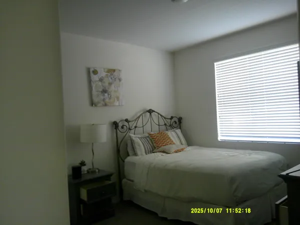 a bedroom with a bed and a window