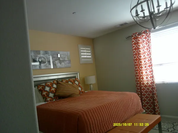 a bedroom with a bed and window