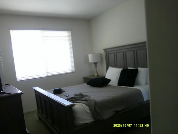 a bedroom with a bed and window