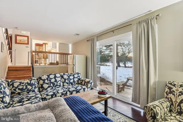 a living room with furniture and a floor to ceiling window