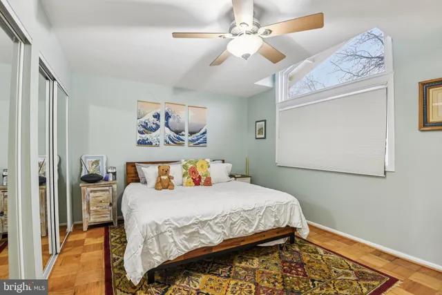 a bedroom with a bed and a painting on the wall