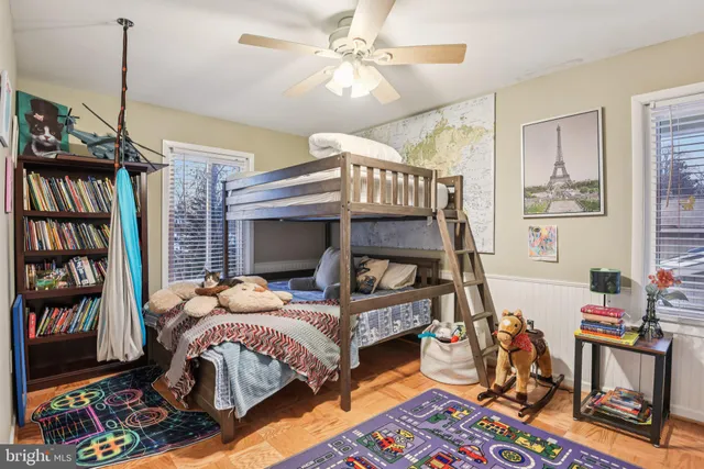 a bedroom with furniture and a book shelf