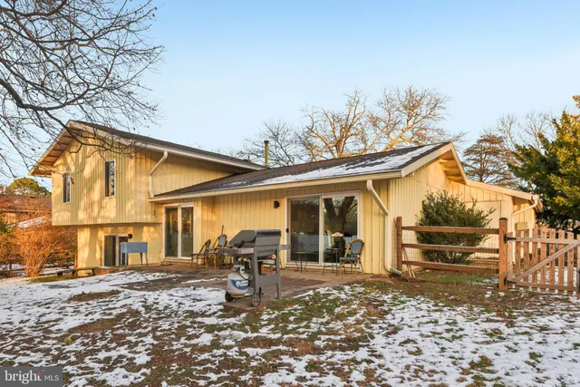 a backyard of a house with barbeque oven table and chairs