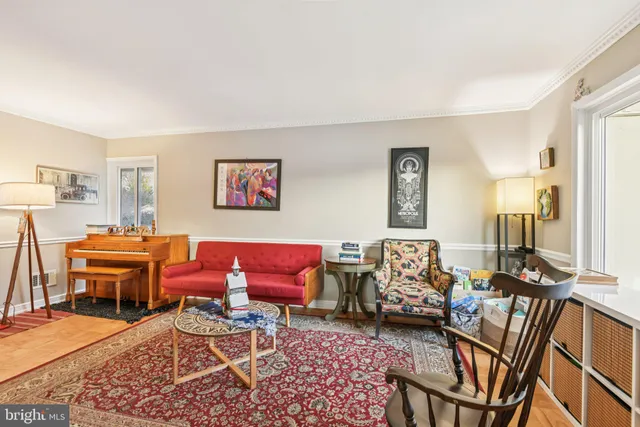 a living room with furniture a rug and a table