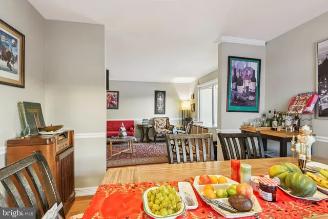 a living room with furniture a rug and a table