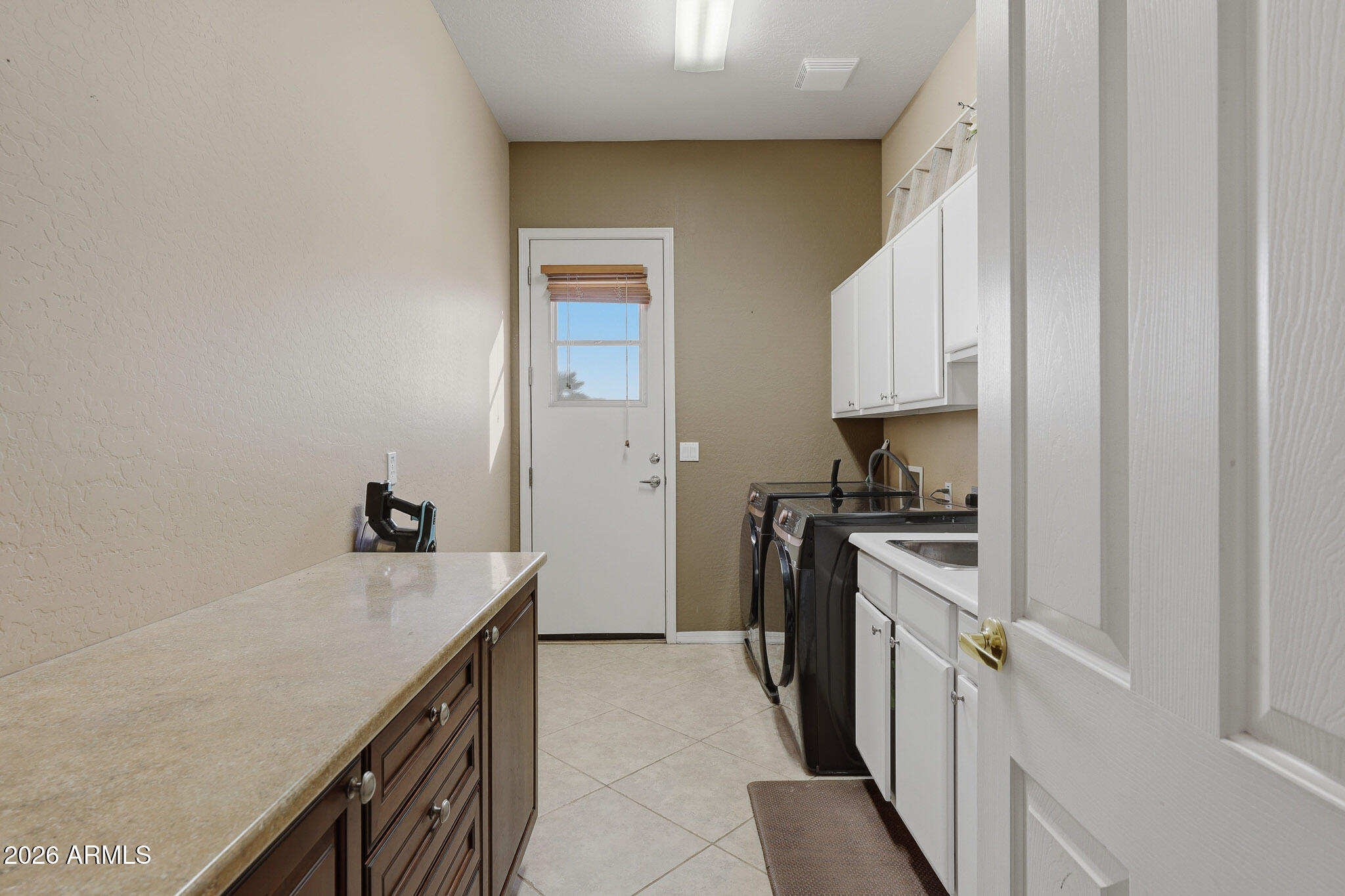 23024 West Sierra Ridge Way Wittmann, AZ 85361 - Photo 38 of 99 a kitchen with a sink stove and refrigerator