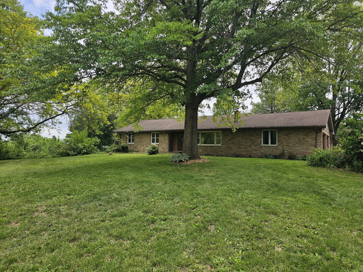 23025 Hazel Road Sterling, IL 61081 - Photo 1 of 29 a front view of a house with garden