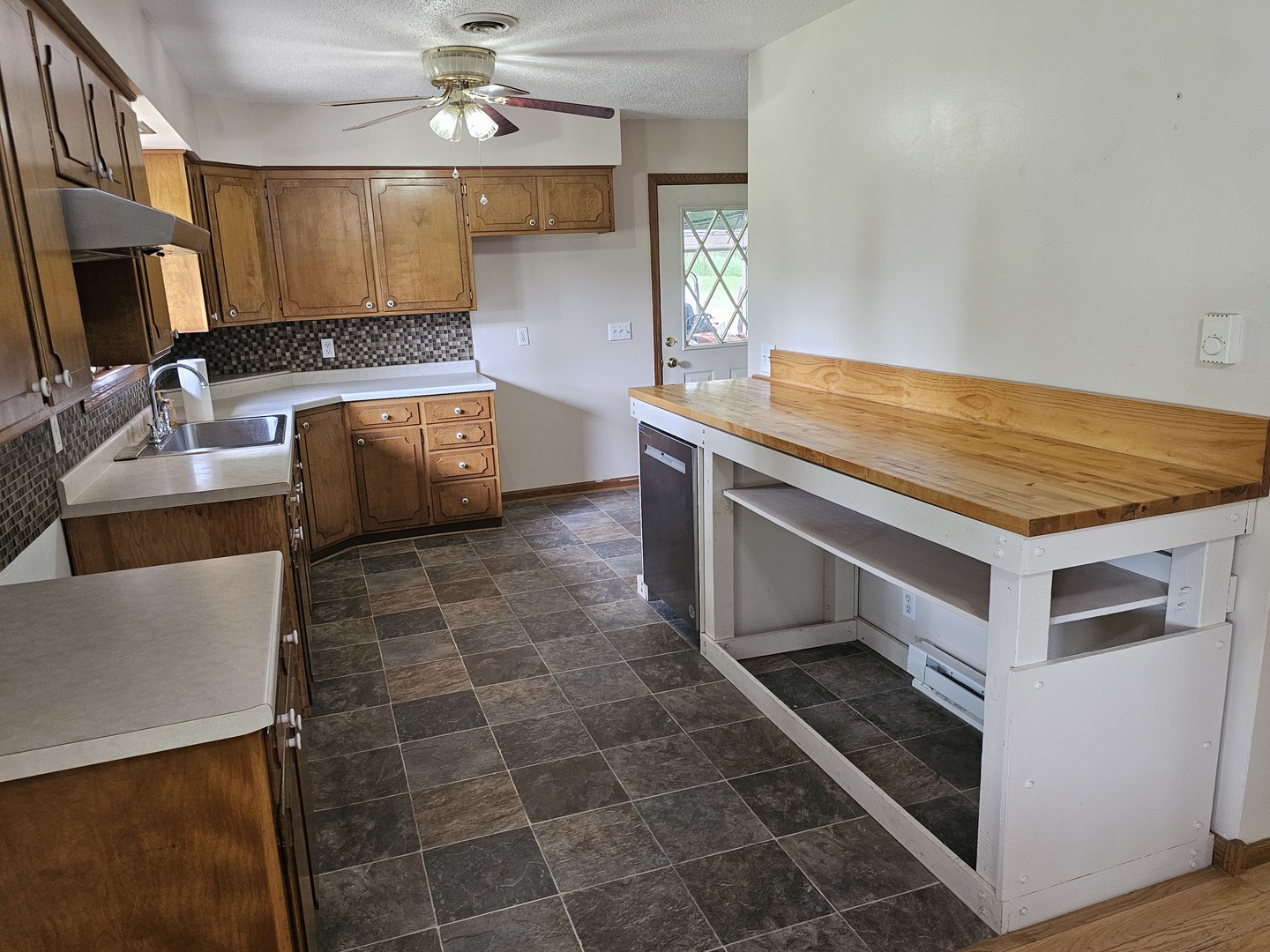 23025 Hazel Road Sterling, IL 61081 - Photo 3 of 29 a kitchen with kitchen island a sink stainless steel appliances and cabinets