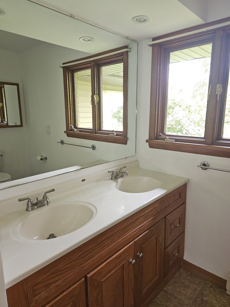 23025 Hazel Road Sterling, IL 61081 - Photo 7 of 29 a bathroom with a sink and a window
