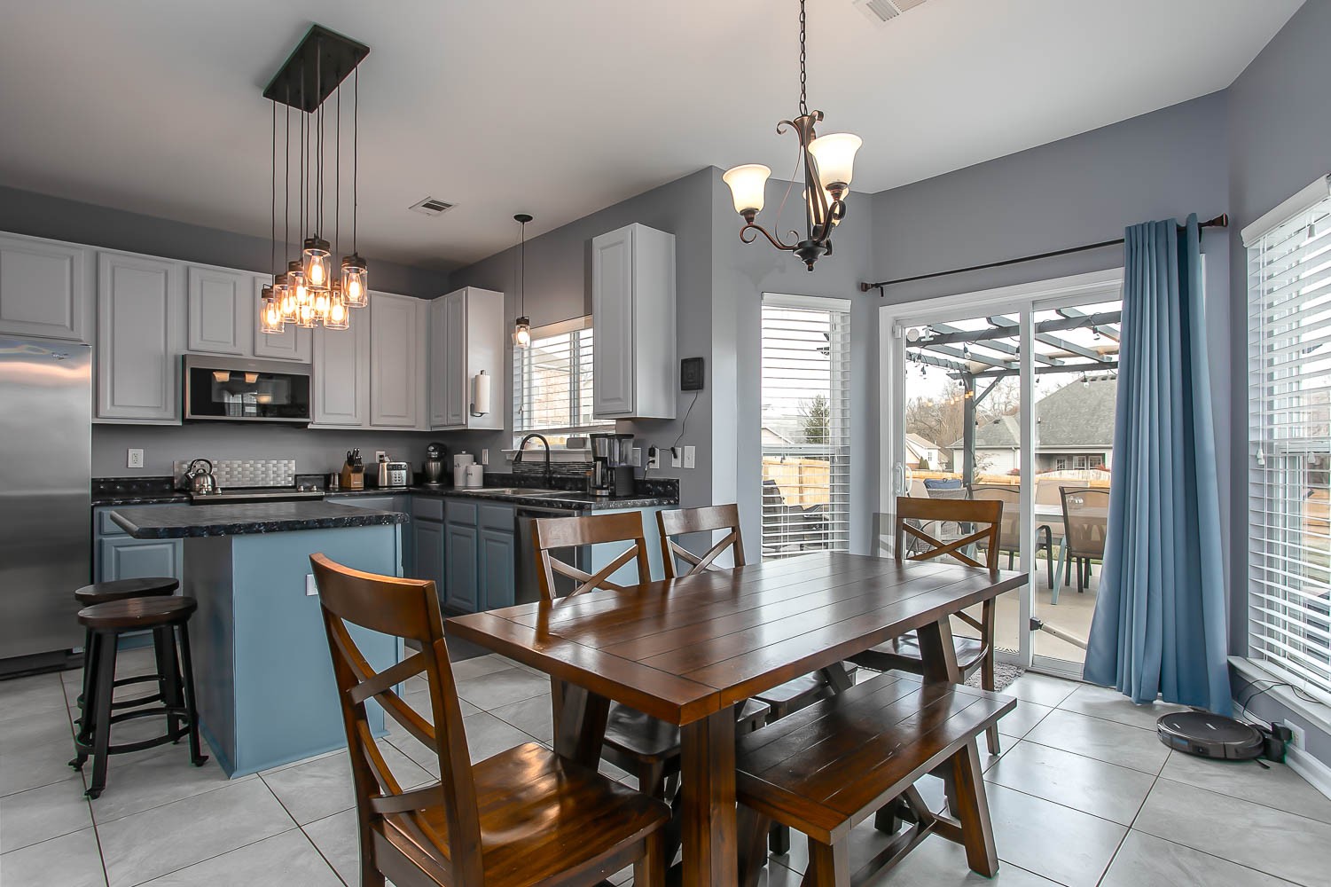 1715 Emma Circle Spring Hill, TN 37174 - Photo 5 of 17 a kitchen with a dining table chairs and chandelier