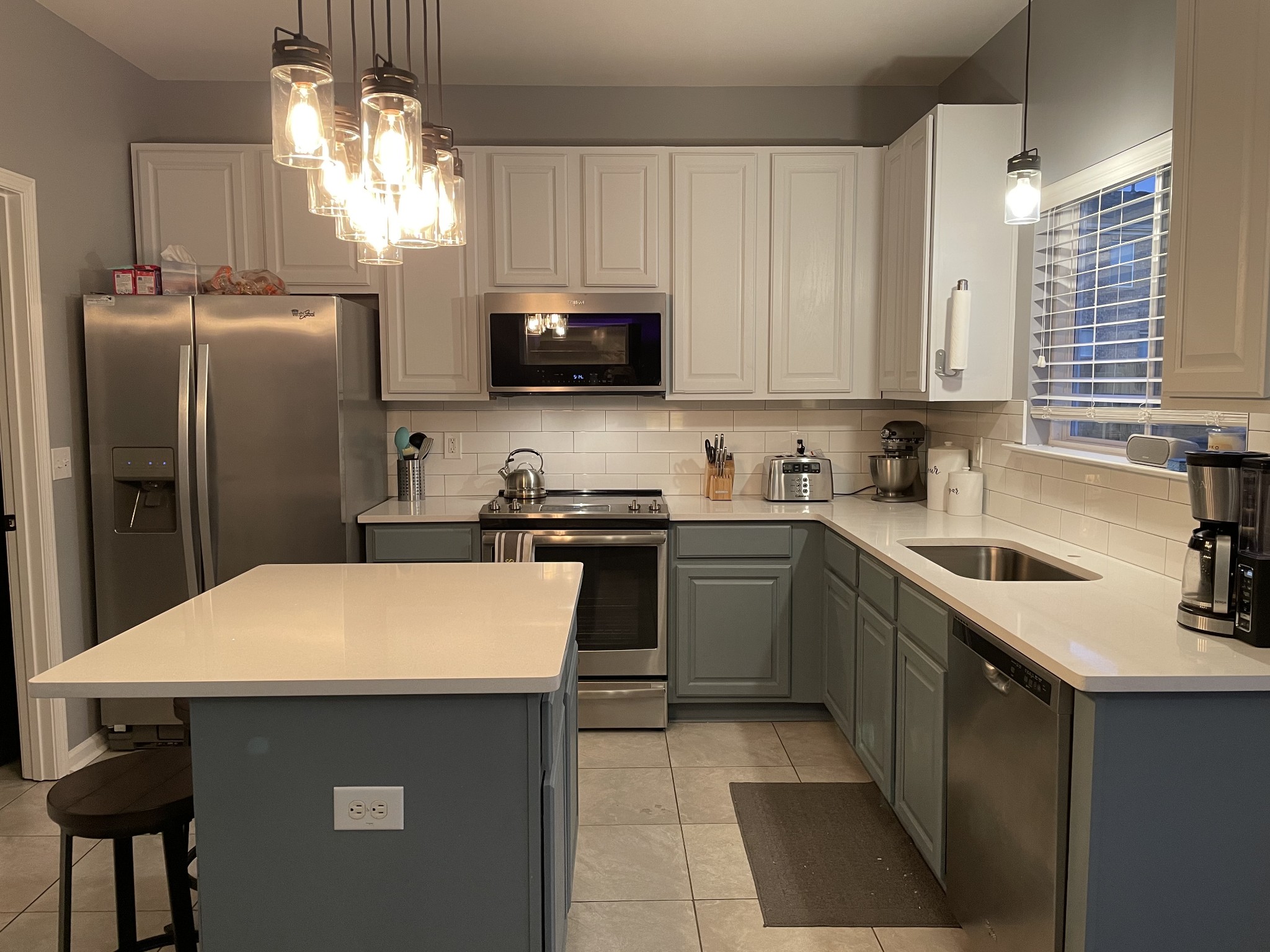 1715 Emma Circle Spring Hill, TN 37174 - Photo 6 of 17 a kitchen with a sink a microwave a refrigerator and cabinets