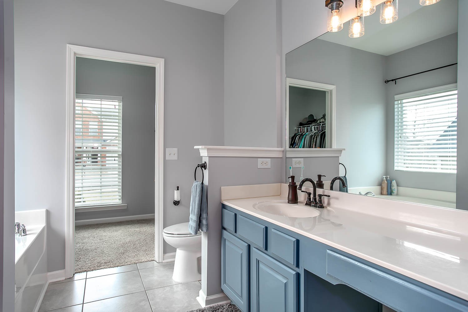 1715 Emma Circle Spring Hill, TN 37174 - Photo 8 of 17 a bathroom with a sink a toilet and a large mirror