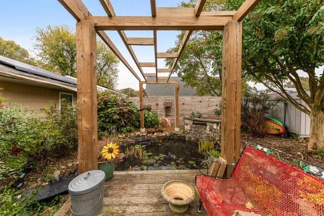 a view of a porch with furniture and wooden floor