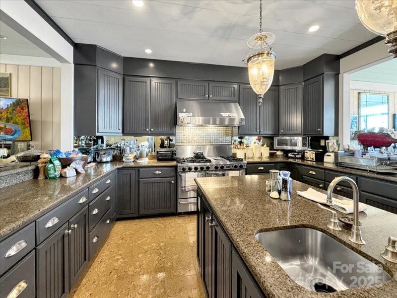 116 Dana Road Waynesville, NC 28786 - Photo 11 of 42 a kitchen with stainless steel appliances granite countertop a sink a stove and a wooden cabinets