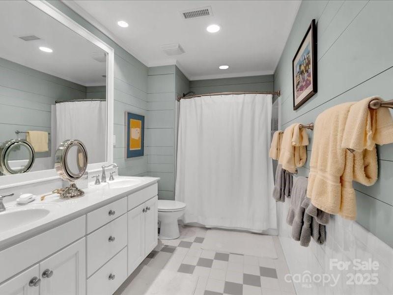 116 Dana Road Waynesville, NC 28786 - Photo 28 of 42 a bathroom with a double vanity sink and mirror