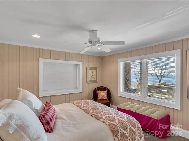 a bedroom with a large bed and a window