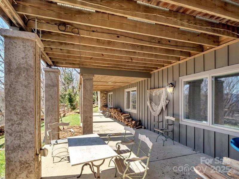 116 Dana Road Waynesville, NC 28786 - Photo 35 of 42 a view of a porch with furniture and floor to ceiling window
