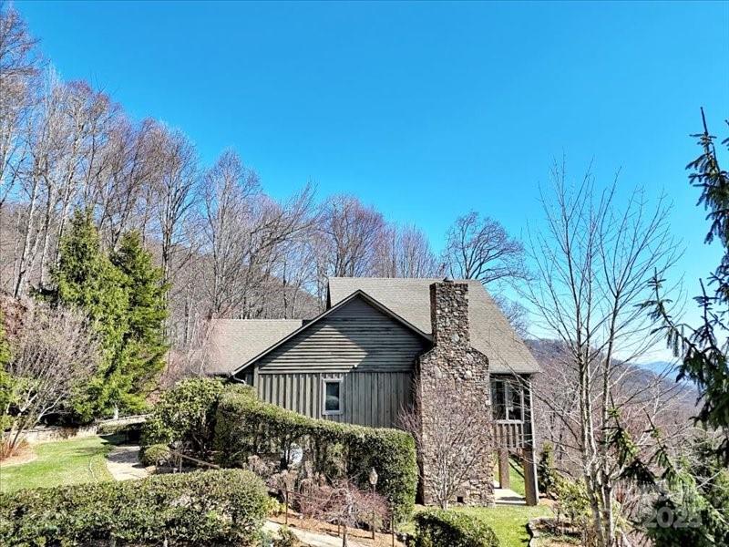 116 Dana Road Waynesville, NC 28786 - Photo 41 of 42 a front view of a house with a garden and tree