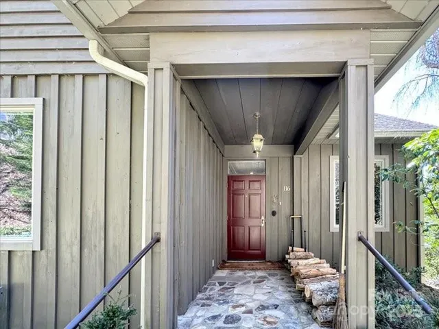 a view of a hallway with wooden floor and entryway