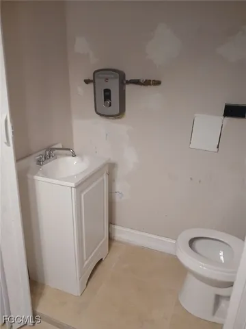 a bathroom with a toilet sink and vanity