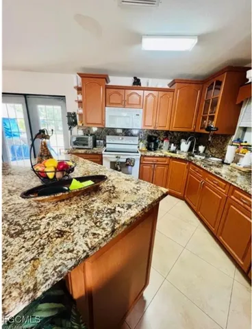 a kitchen with stainless steel appliances granite countertop a sink stove and cabinets